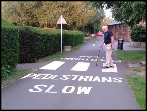 Alan Myers demonstrates how to cross a road slowly, very slowly.