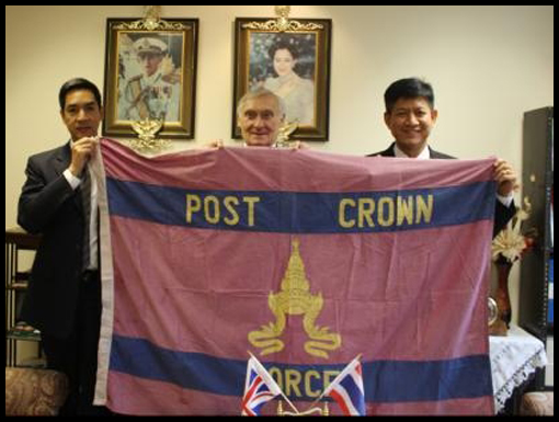 The Thai DA and ADA support the Post Crown flag in the Thai Embassy.