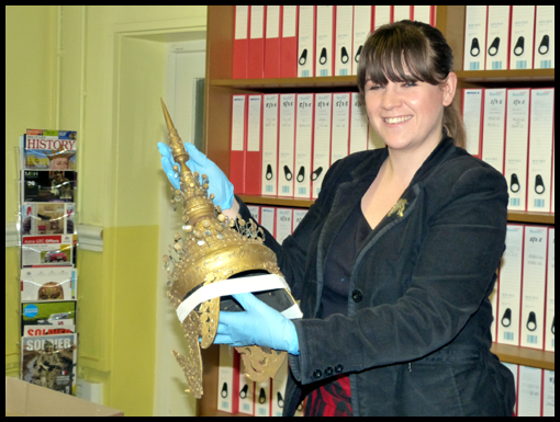 The Assisitant RE Museum Curator holds a Thai Princess Crown.