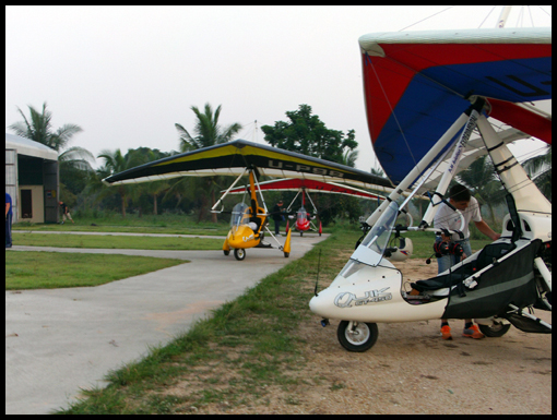 Three Flexwing microlights sit awaiting the coming flight.