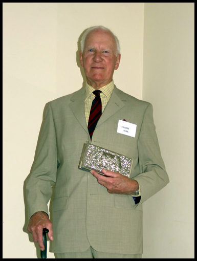 major Freddie Rose holds the silver cigarette case presented to him by the Thai Government as a symbol of their gratitude for his work on the Post Crown Road.