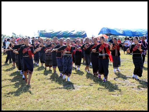 The OCA  group are escorted by dancers to their seats in the marquee.