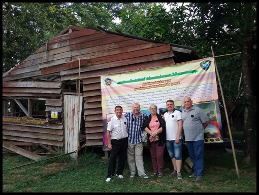 The group pose in front of a long abandoned accomadation hut.