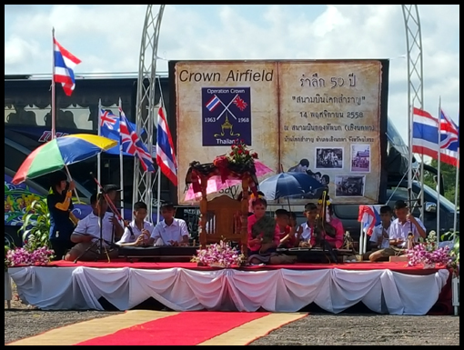 The school orchestra palys traditional Laos music as the participants socialise.