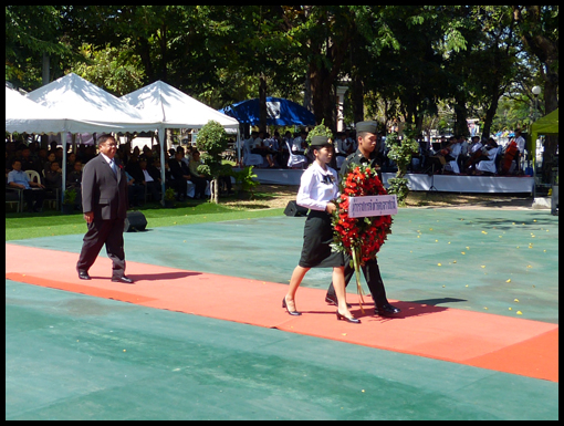 The Governor of Ubon wals behind the wreath he is about to lay.