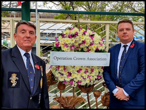 Mark and dad Neville pose in front of the OCA wreath. Rollover shows Noel Jackson standing with an OCA group.
