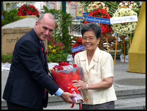 Mike Chapman presents a bouquet to a relative of 'Little Mother Ubon'