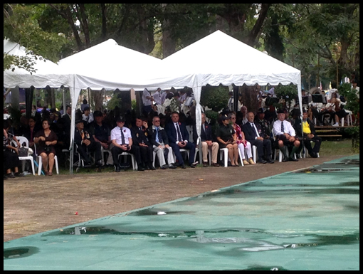 The group take their seats in the marquee.