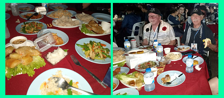 A dinner table full of colourful dishes.