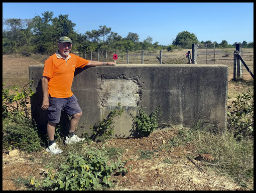 Jim Curtis stands beside a concrete plinth at the entrance to what was Crown Camp.