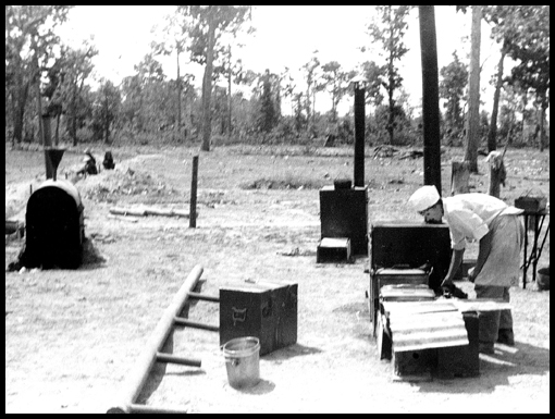 Harry Colley hard at work, preparing a meal for the camp inhabitants