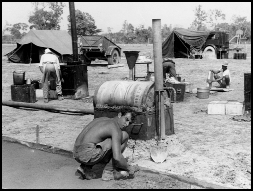 L/Cpl Harry Colley hard at work cooking and serving his culinary delights.