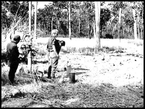 Stewart Hulley with Thai civilian helpers, reconnoiters the road centerline.