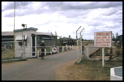 A Thai Army MP stands guard at the main gate to the RAAF base at Ubon. Picture taken in 1965